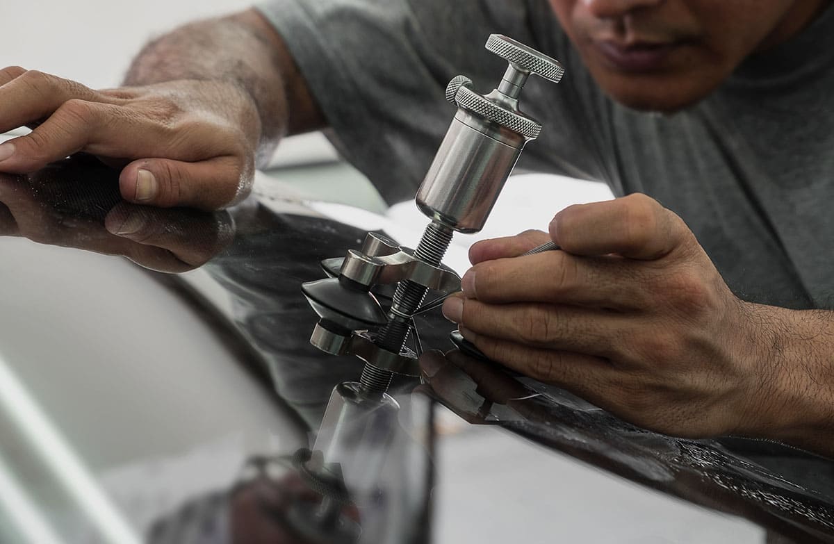 a men repairing a windshield