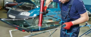 a men repair a windshield